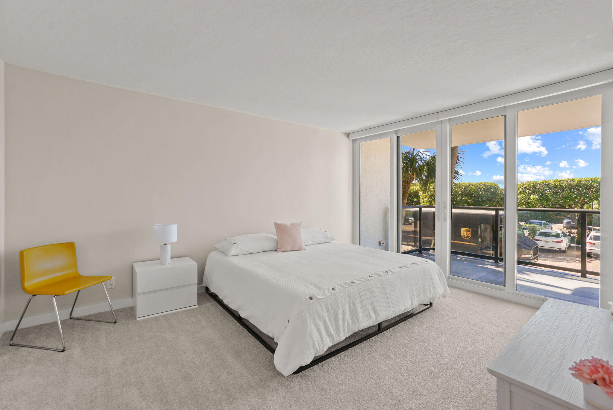 3440 South Ocean Boulevard, Unit 105S Palm Beach, FL 33480 - Photo 24 of 77 a bedroom with a bed a couch and a large window with outer view