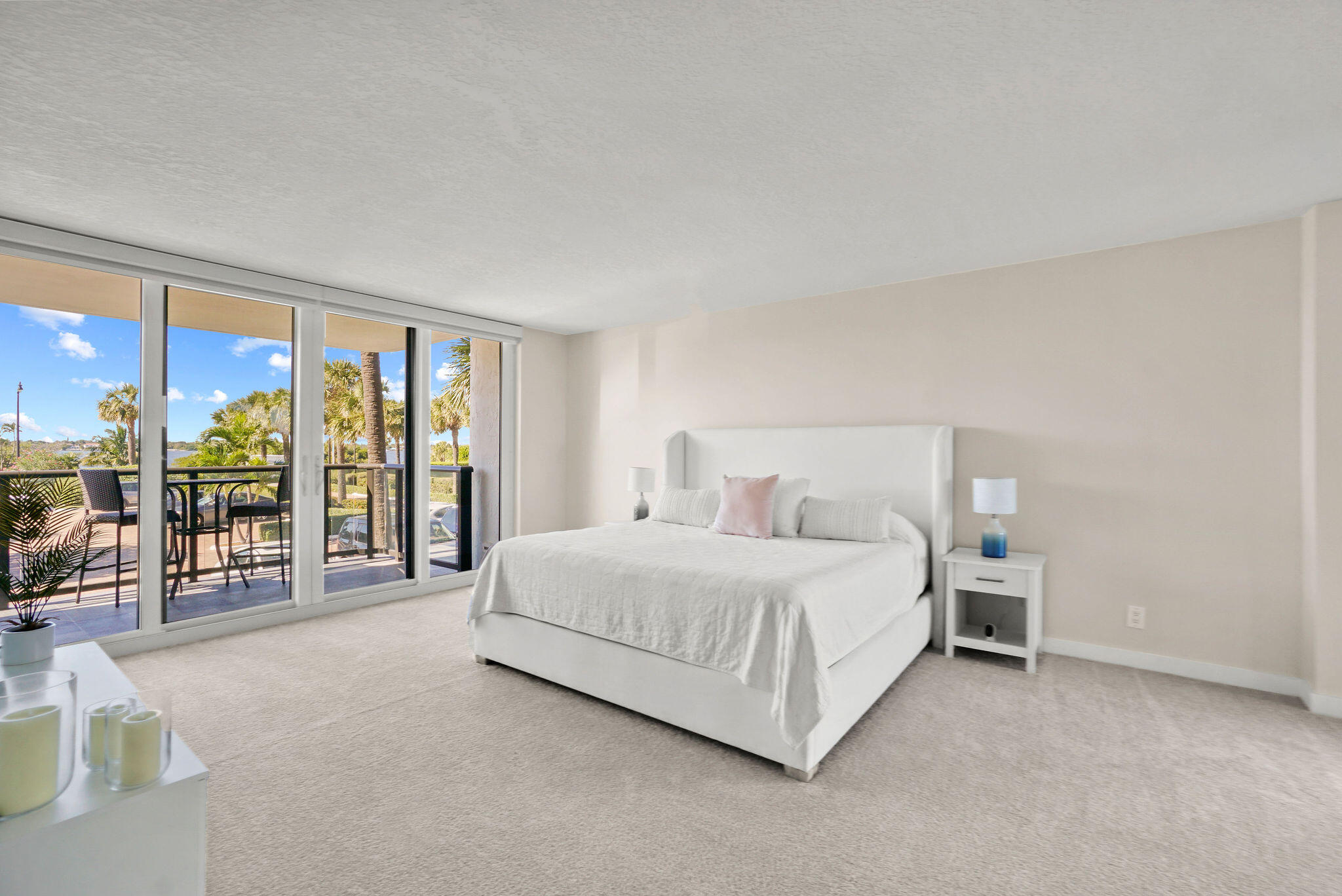 3440 South Ocean Boulevard, Unit 105S Palm Beach, FL 33480 - Photo 28 of 77 a bedroom with a large bed and a balcony view