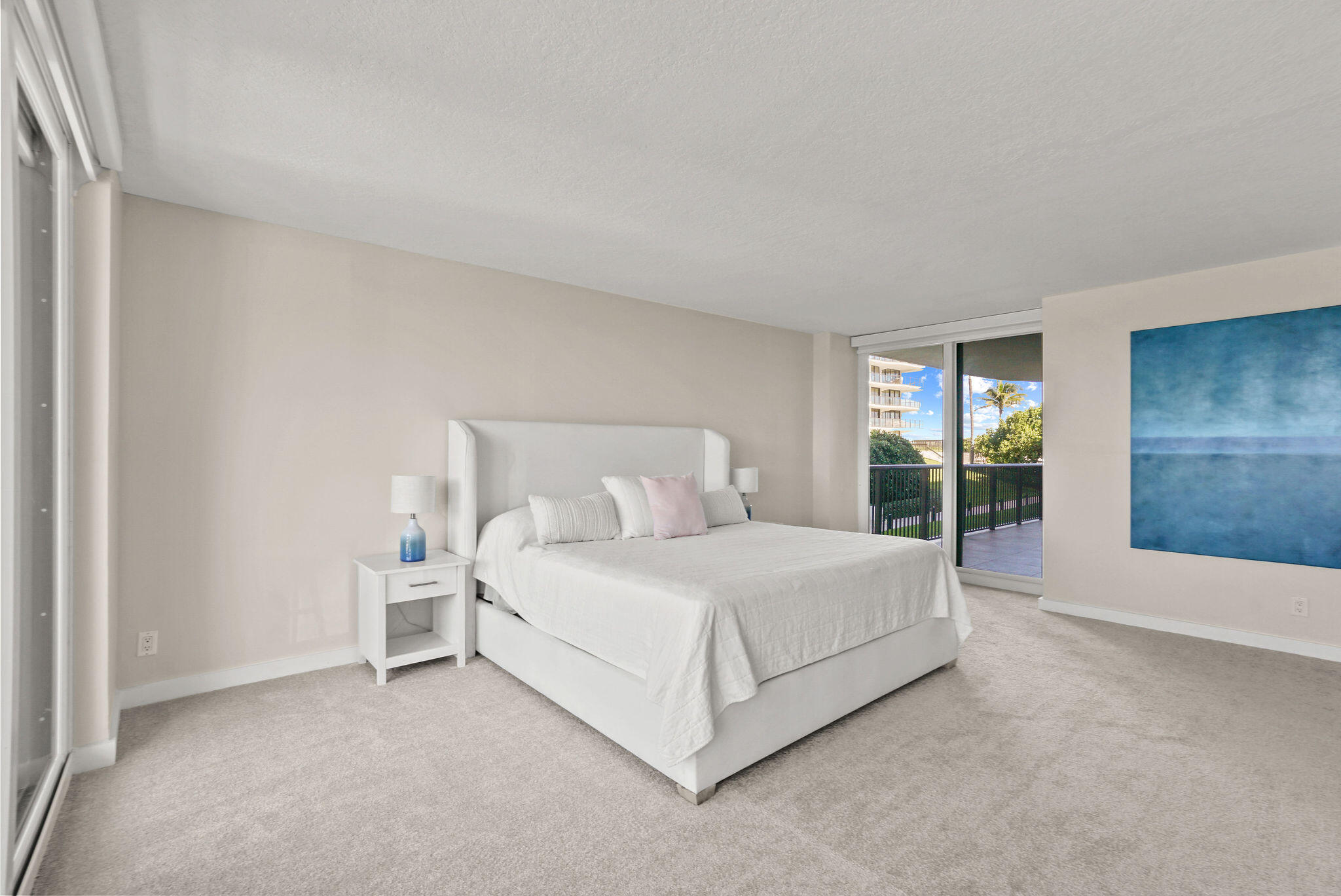 3440 South Ocean Boulevard, Unit 105S Palm Beach, FL 33480 - Photo 32 of 77 a bed room with a bed and a large window