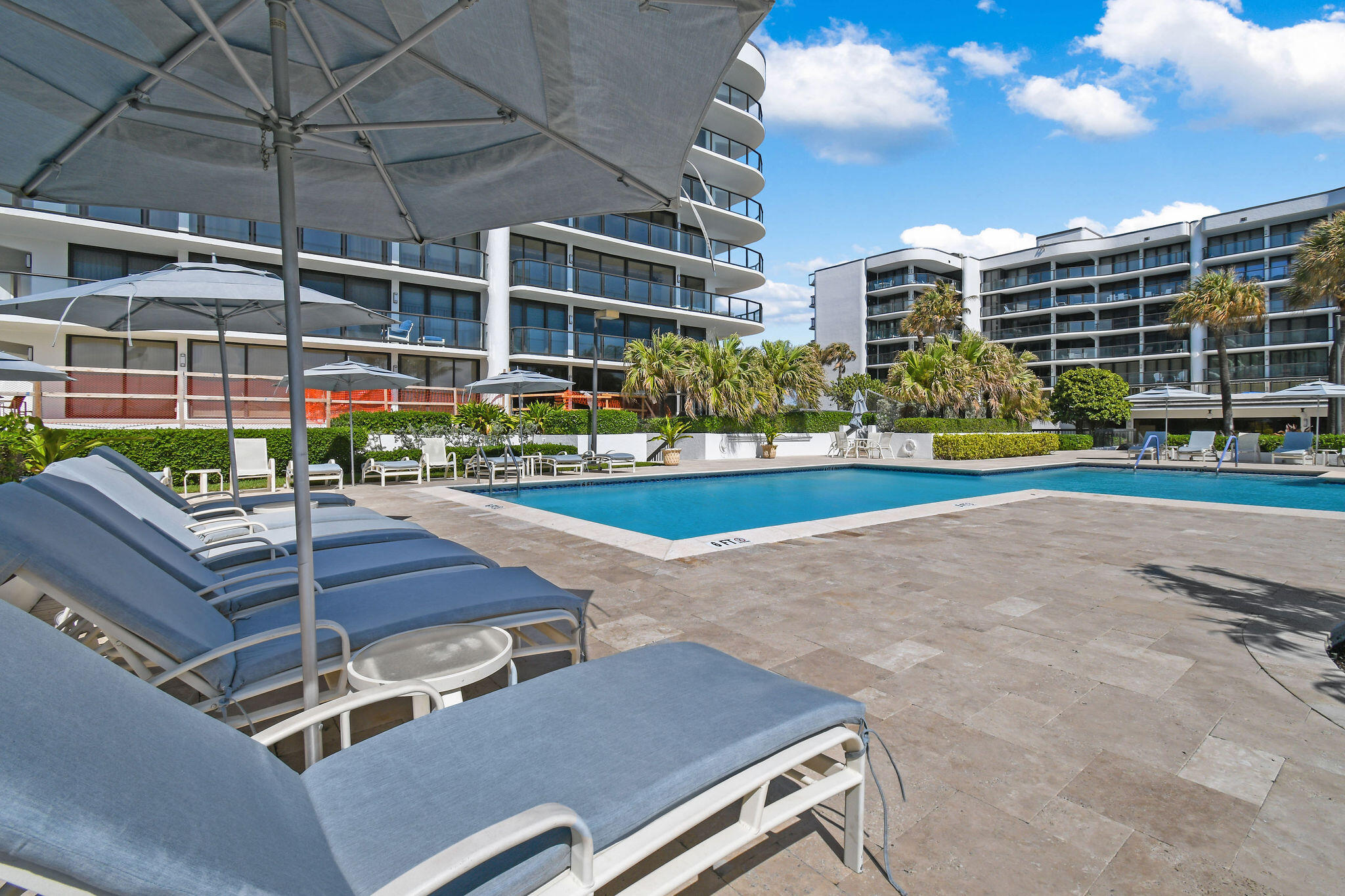3440 South Ocean Boulevard, Unit 105S Palm Beach, FL 33480 - Photo 54 of 77 a view of a swimming pool with a patio and plants