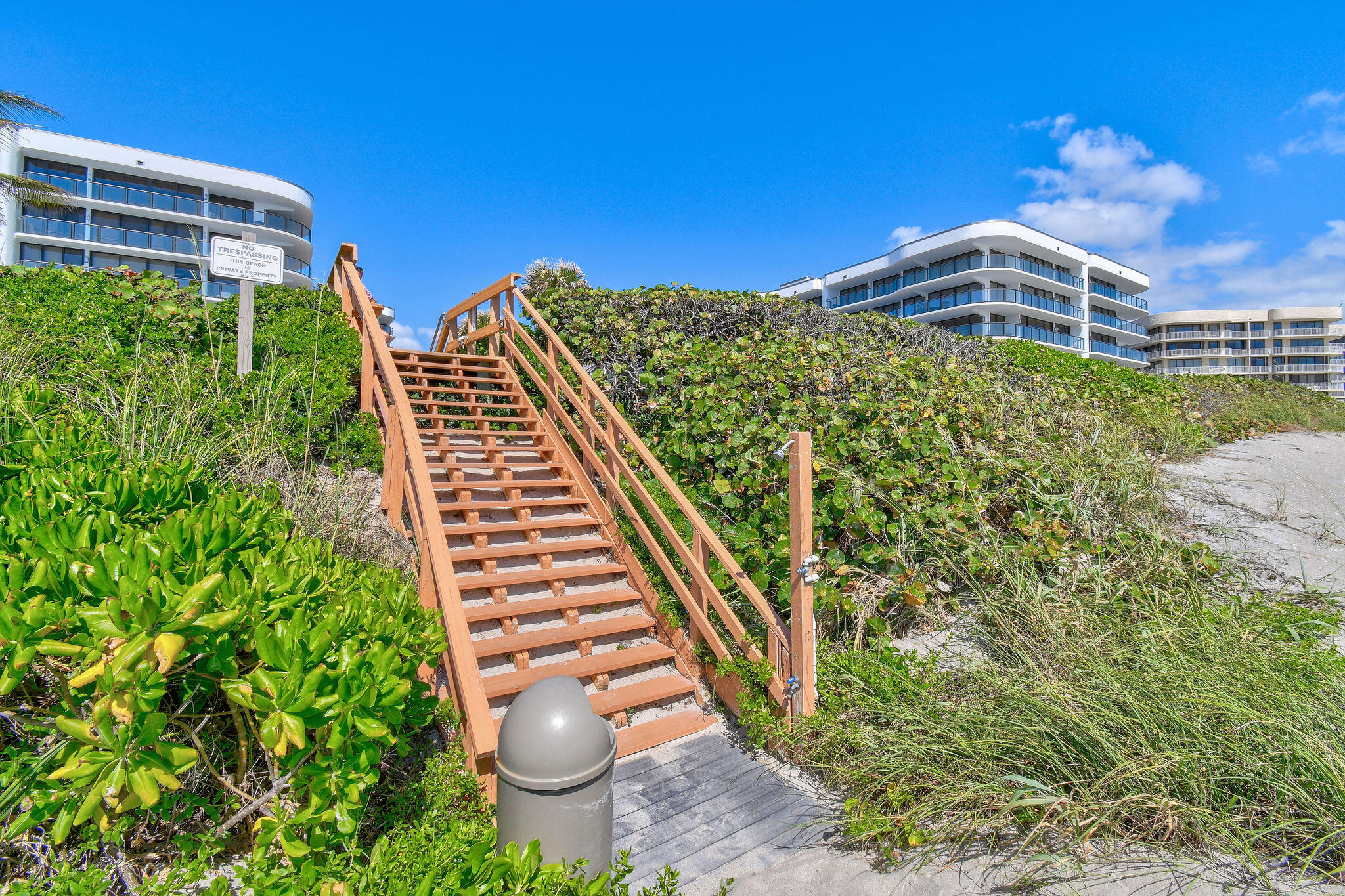 3440 South Ocean Boulevard, Unit 105S Palm Beach, FL 33480 - Photo 60 of 77 a view of a tall building with a yard and plants