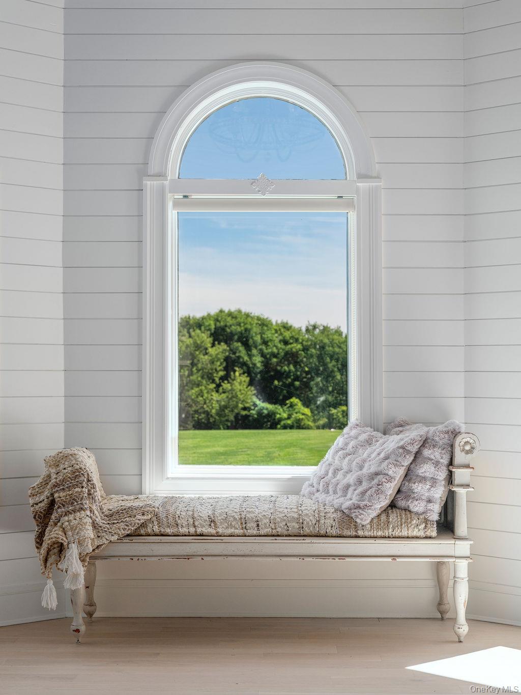 3875 Hallock Lane Mattituck, NY 11952 - Photo 20 of 50 Living area featuring wooden walls, healthy amount of natural light, and wood finished floors