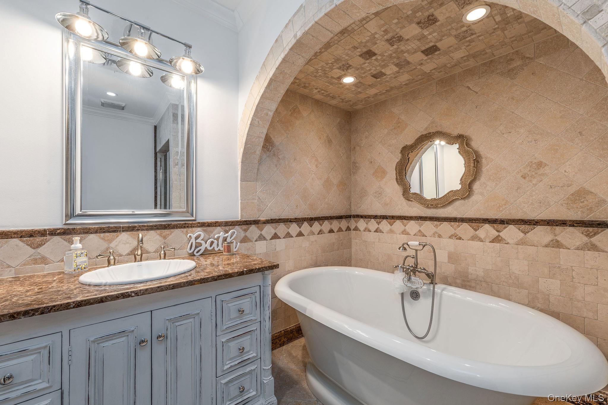 3875 Hallock Lane Mattituck, NY 11952 - Photo 28 of 50 Full bathroom with a freestanding bath, tile walls, vanity, crown molding, and recessed lighting