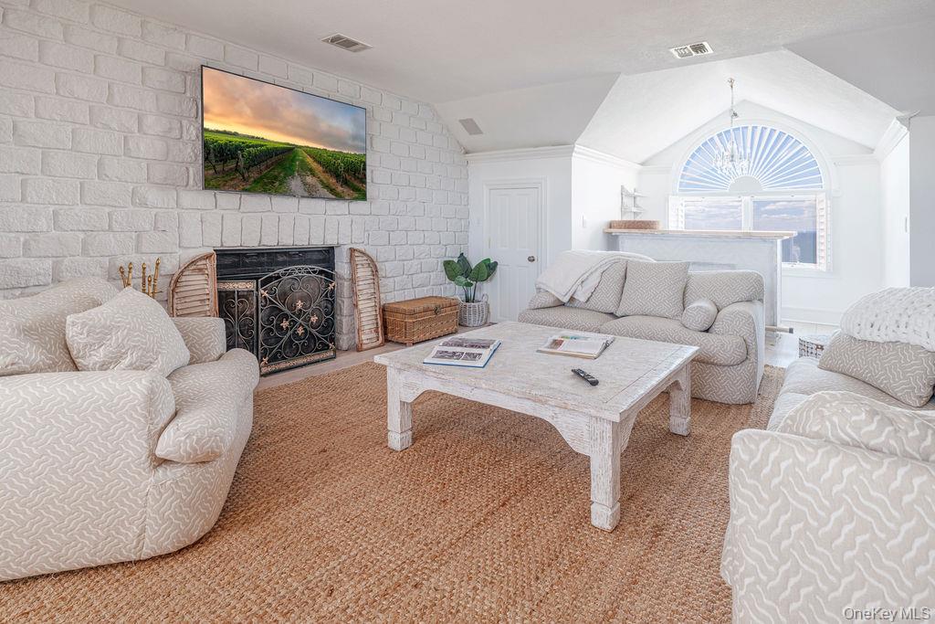 3875 Hallock Lane Mattituck, NY 11952 - Photo 29 of 50 Living room featuring lofted ceiling and a fireplace