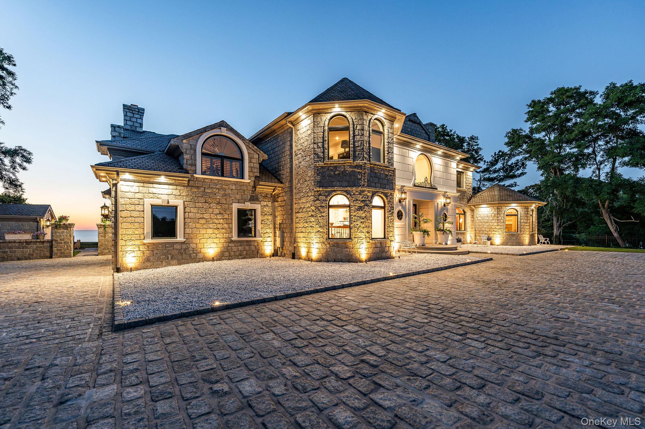 3875 Hallock Lane Mattituck, NY 11952 - Photo 39 of 50 View of front of house with a balcony, a chimney, stone siding, and a high end roof