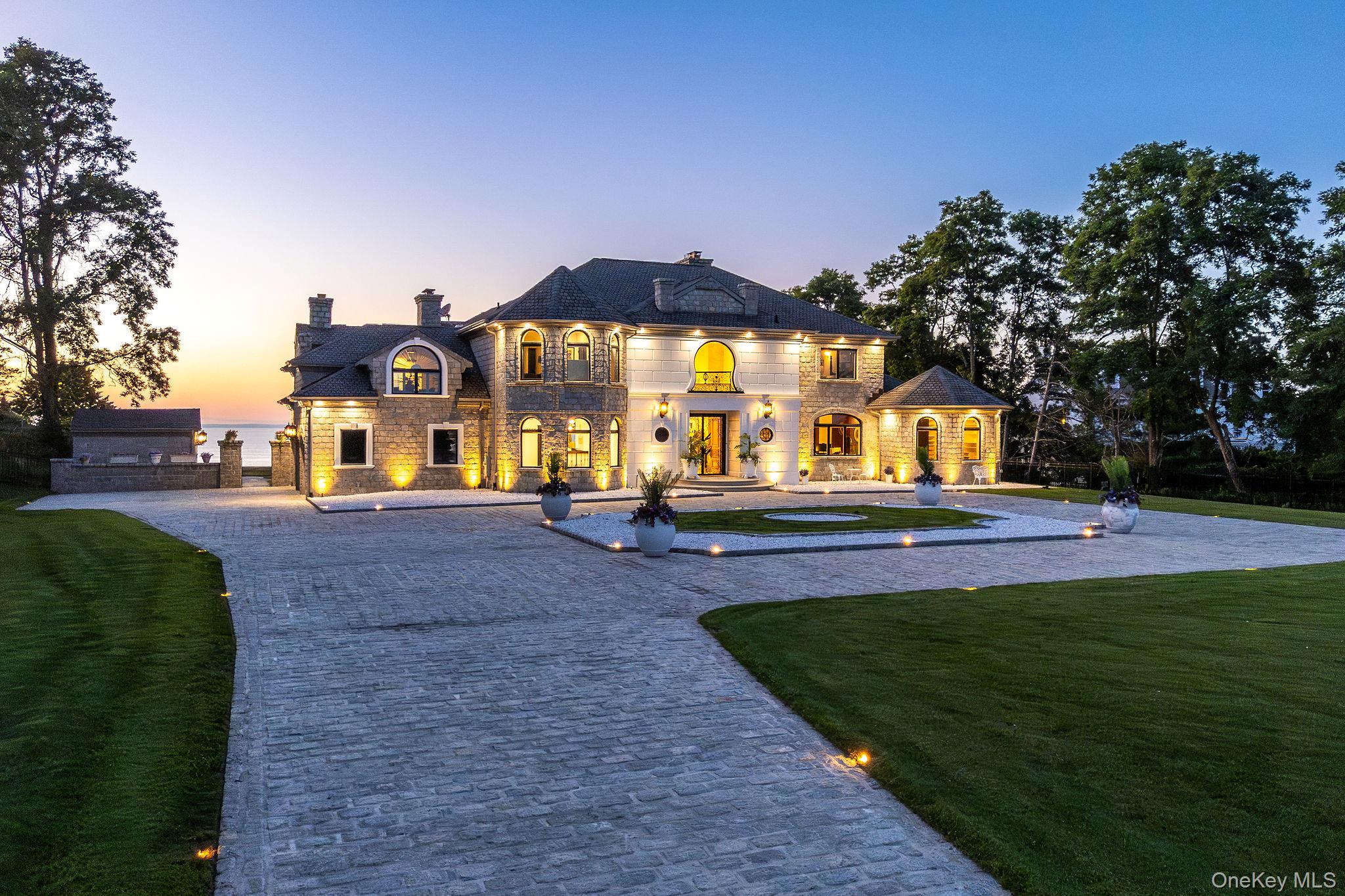3875 Hallock Lane Mattituck, NY 11952 - Photo 40 of 50 Rear view of house with a chimney, curved driveway, a yard, and stone siding
