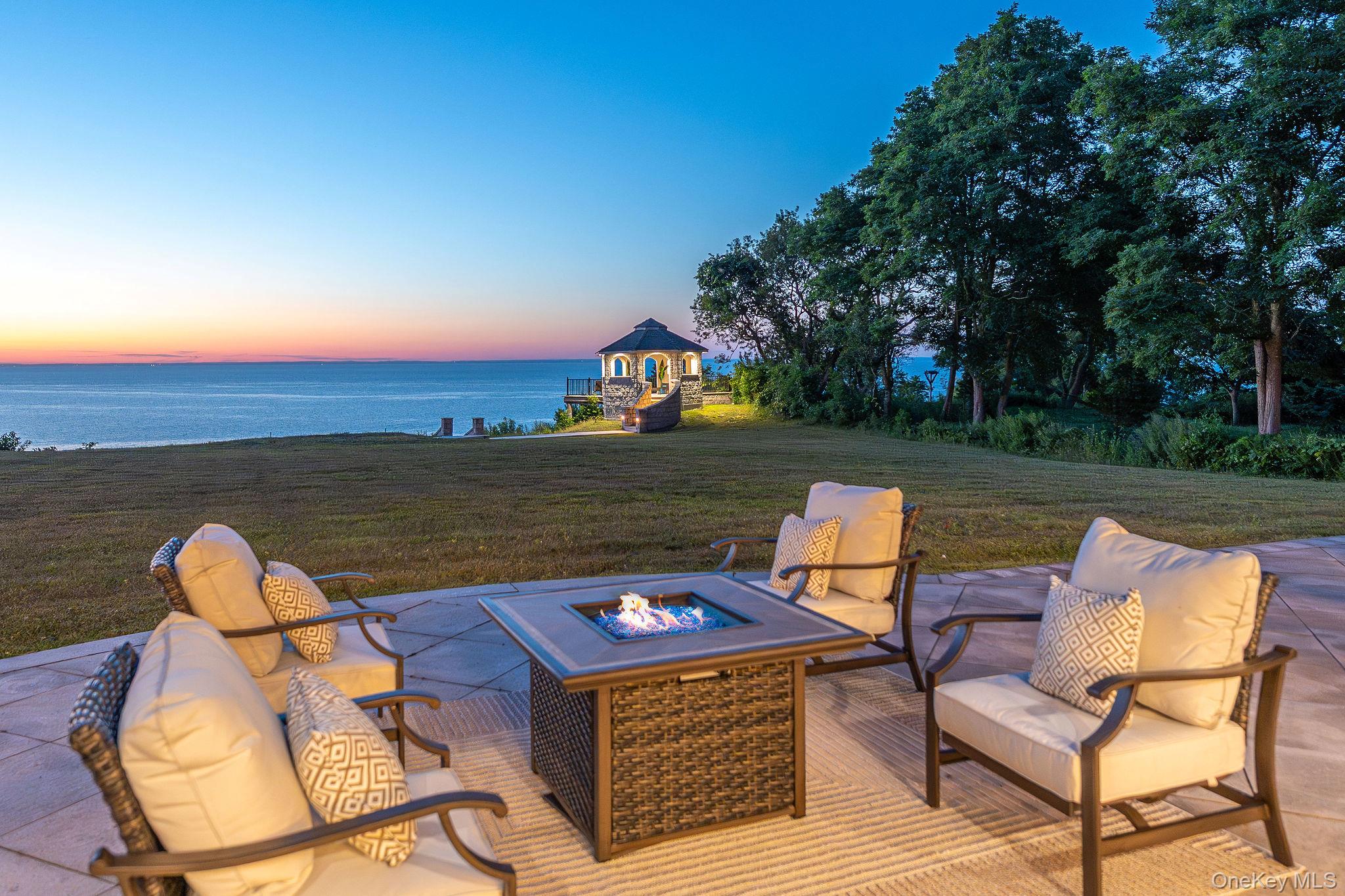3875 Hallock Lane Mattituck, NY 11952 - Photo 4 of 50 View of patio with a water view and a fire pit