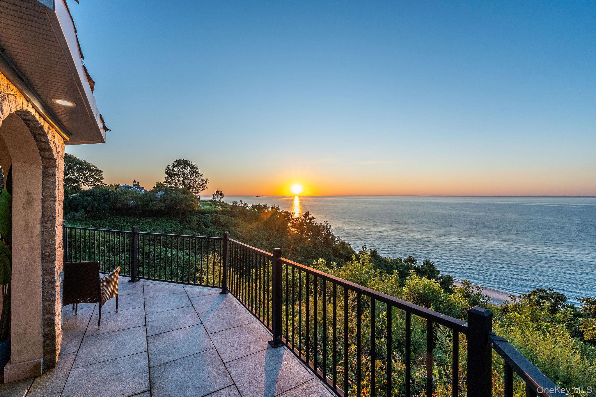 3875 Hallock Lane Mattituck, NY 11952 - Photo 44 of 50 Balcony at dusk featuring a water view and a patio