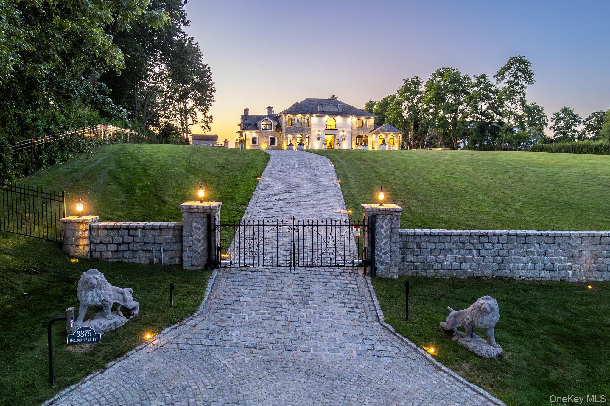 3875 Hallock Lane Mattituck, NY 11952 - Photo 45 of 50 French provincial home featuring a gate, a fenced front yard, decorative driveway, and a chimney