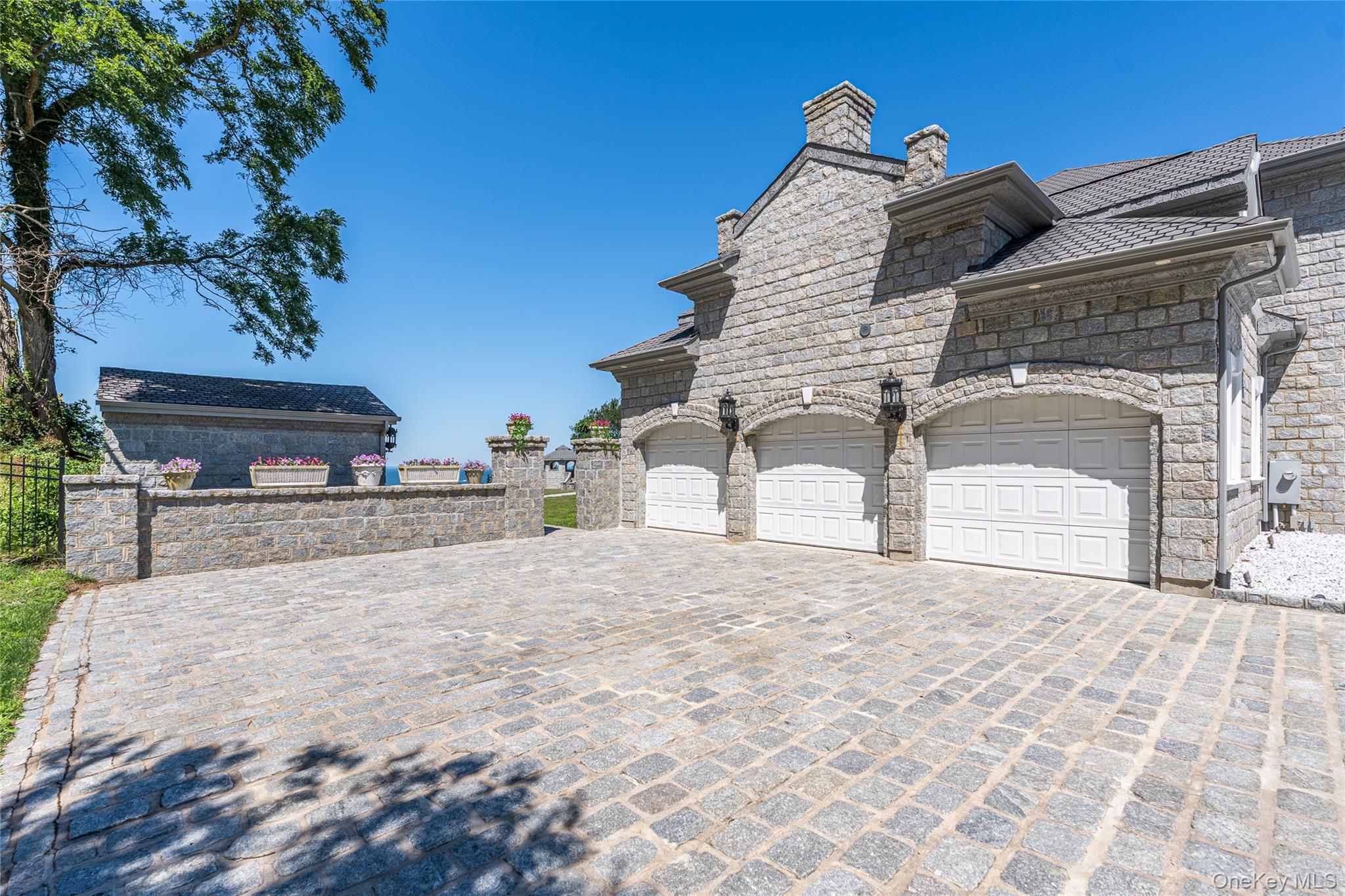 3875 Hallock Lane Mattituck, NY 11952 - Photo 49 of 50 View of side of home featuring decorative driveway and stone siding