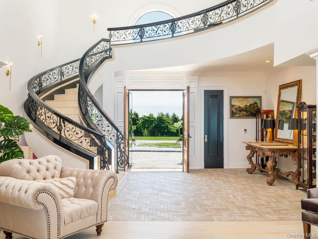 3875 Hallock Lane Mattituck, NY 11952 - Photo 7 of 50 Foyer entrance featuring stairs, parquet flooring, and a towering ceiling