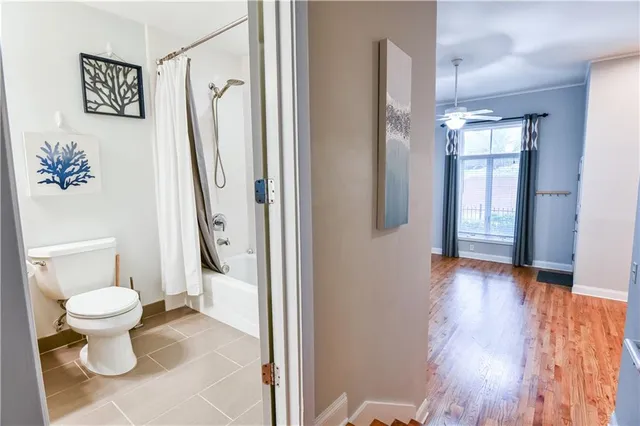 a bathroom with a toilet sink and a mirror