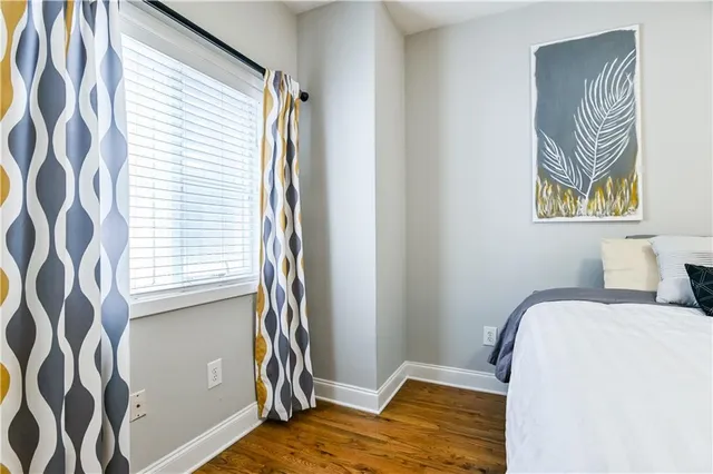 a bedroom with a bed and a painting on the wall