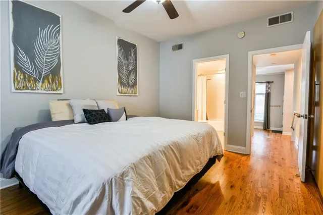 a bedroom with bed and wooden floor