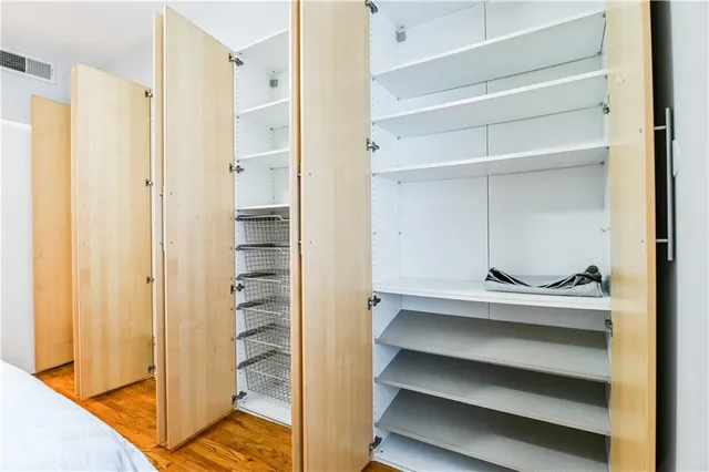a view of walk in closet with empty racks