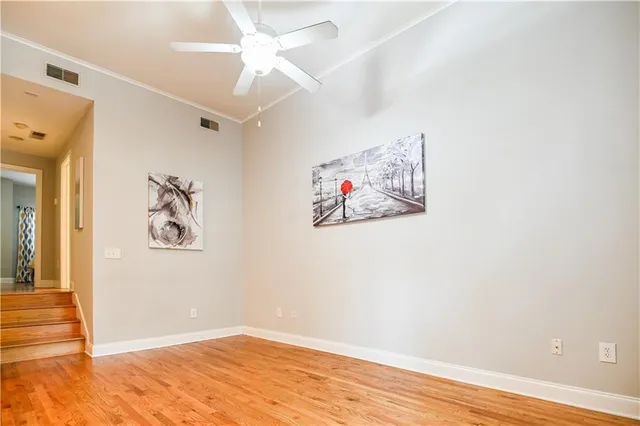 a view of a hallway with wooden floor and closet