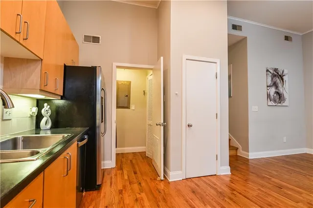 a kitchen with a refrigerator and a sink