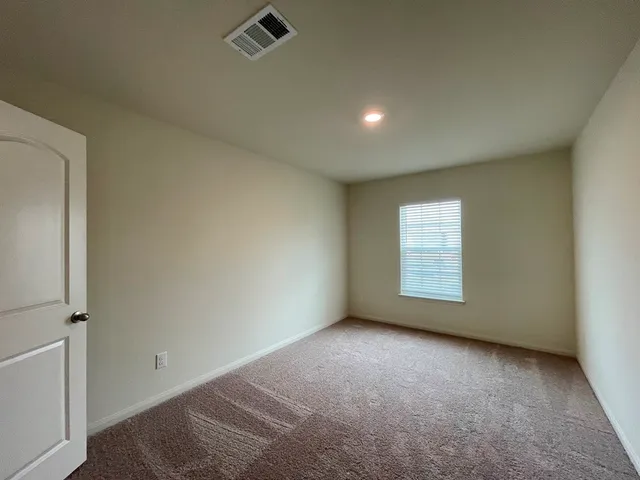 an empty room with a empty space and windows