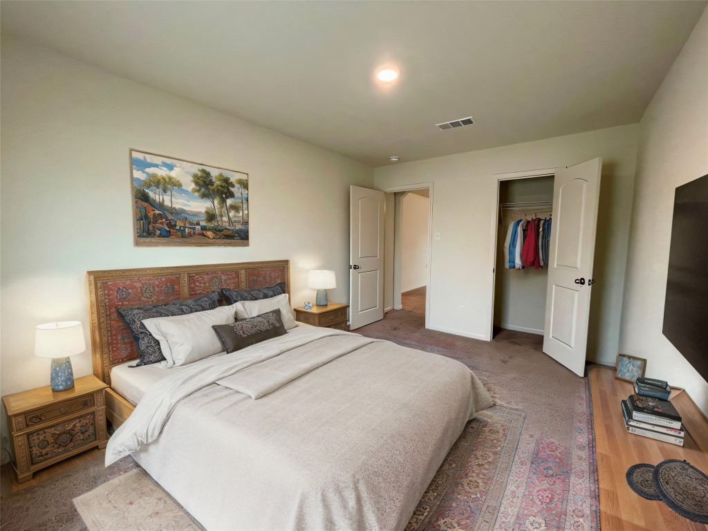 168 Allington Circle Jarrell, TX 76537 - Photo 20 of 40 a bedroom with bed and a flat screen tv