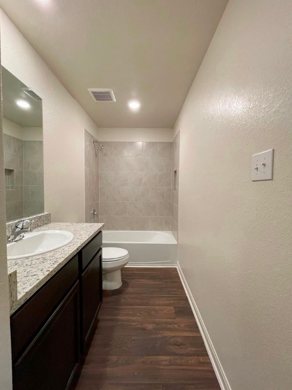 168 Allington Circle Jarrell, TX 76537 - Photo 25 of 40 a bathroom with a granite countertop sink a toilet and a bathtub