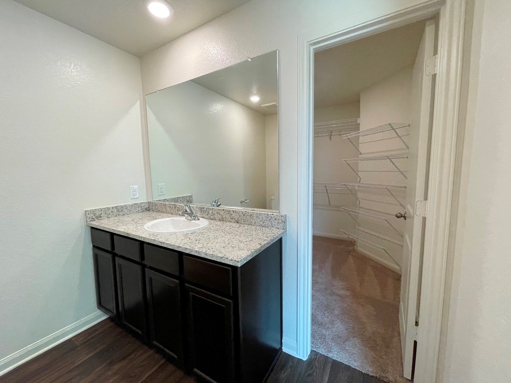 168 Allington Circle Jarrell, TX 76537 - Photo 33 of 40 a bathroom with a granite countertop sink and a mirror