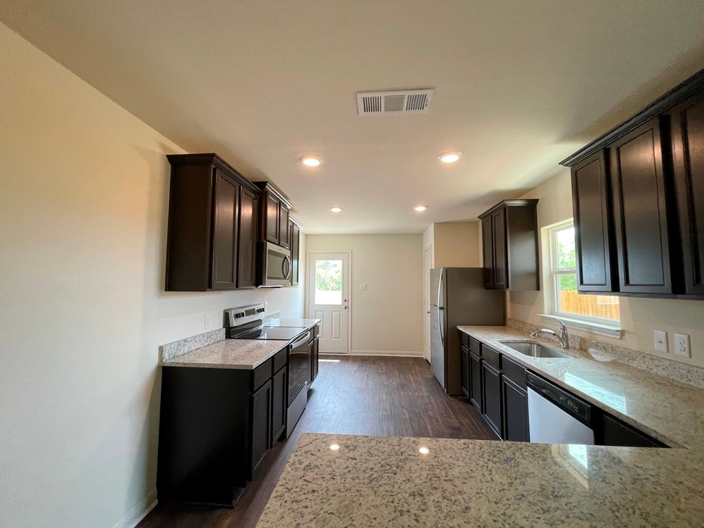 168 Allington Circle Jarrell, TX 76537 - Photo 9 of 40 a large bathroom with a large mirror vanity and sink