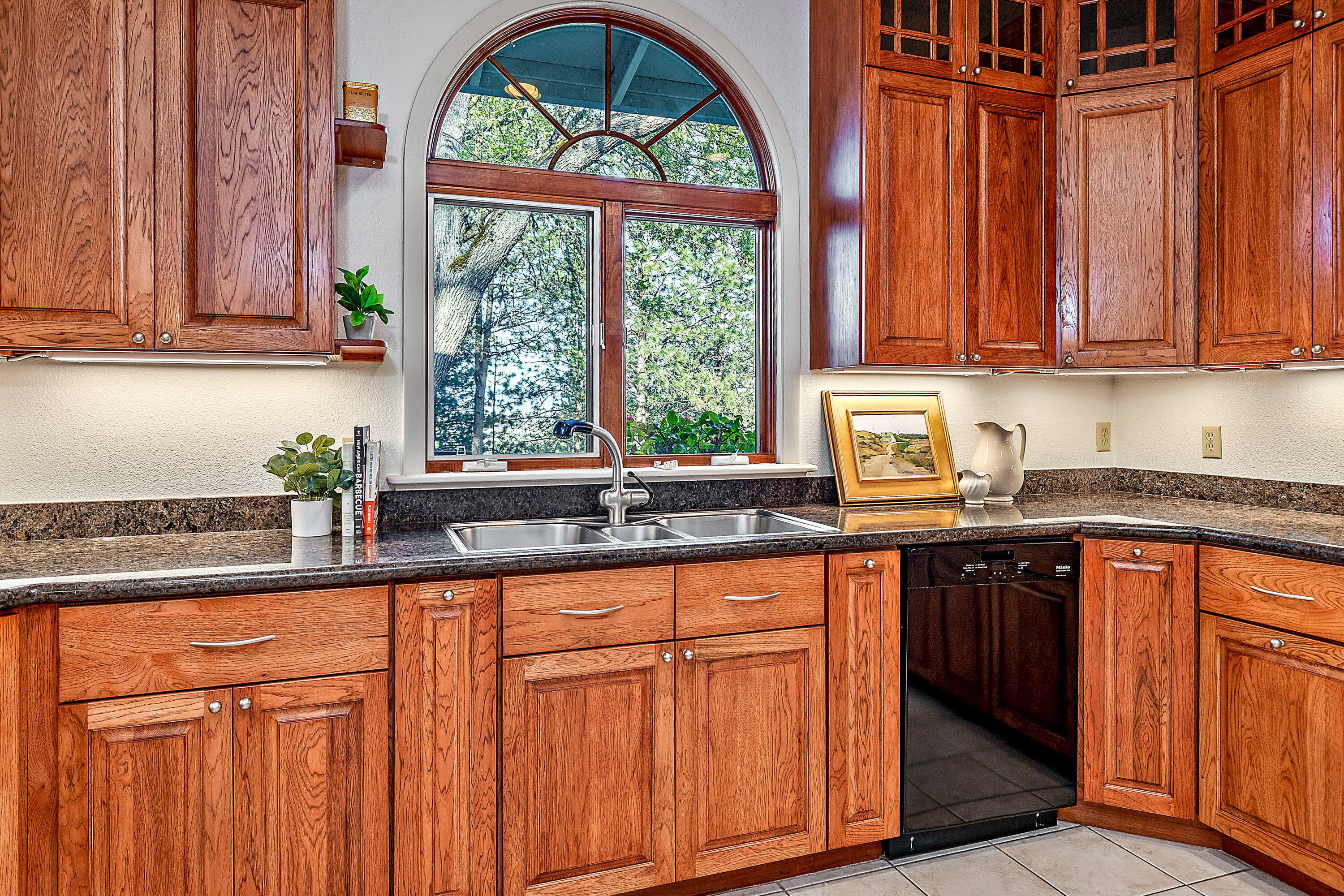 3333 Old Stage Road Central Point, OR 97502 - Photo 43 of 68 a kitchen with stainless steel appliances wooden cabinets a sink and a large window