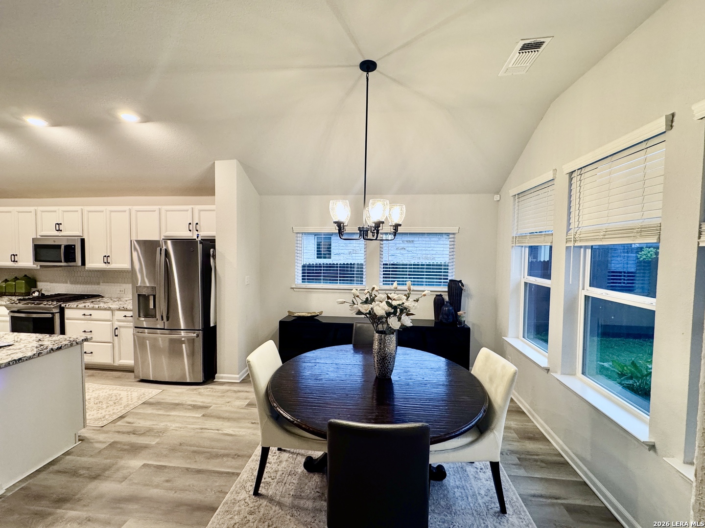 142 Willamette Way Kyle, TX 78640 - Photo 13 of 29 a dining room with furniture a window and kitchen view