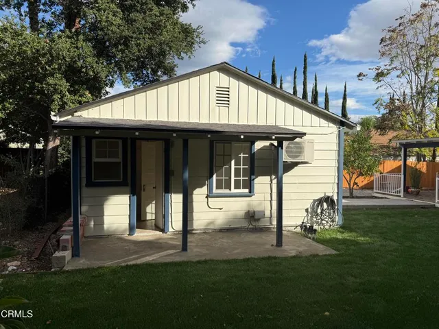 a front view of a house with a yard and porch