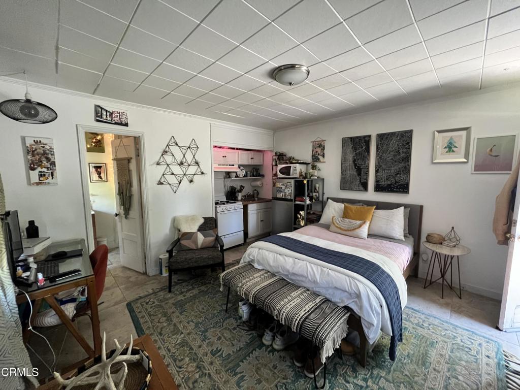 1445 East Woodbury Road, Unit REAR Pasadena, CA 91104 - Photo 11 of 17 a bedroom with a bed and furniture