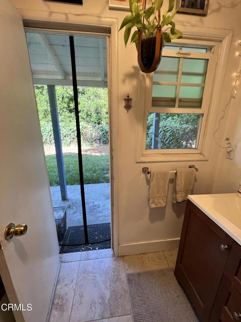 1445 East Woodbury Road, Unit REAR Pasadena, CA 91104 - Photo 13 of 17 a bathroom with a bathtub and window