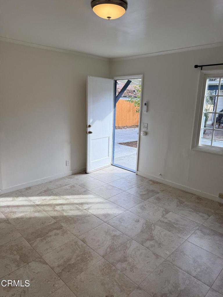 1445 East Woodbury Road, Unit REAR Pasadena, CA 91104 - Photo 5 of 17 a view of a room with a window and fireplace
