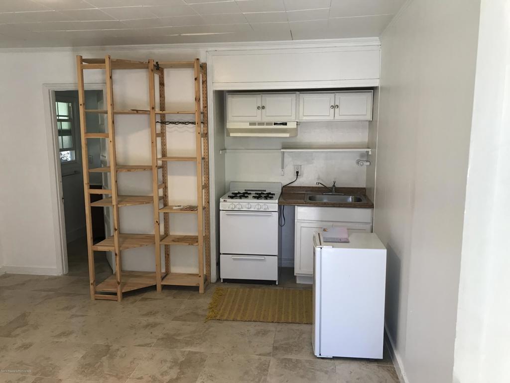 1445 East Woodbury Road, Unit REAR Pasadena, CA 91104 - Photo 7 of 17 a room with storage and utility