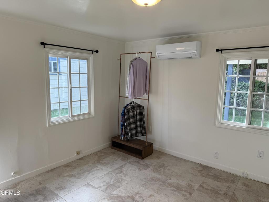 1445 East Woodbury Road, Unit REAR Pasadena, CA 91104 - Photo 8 of 17 wooden floor in an empty room with a window