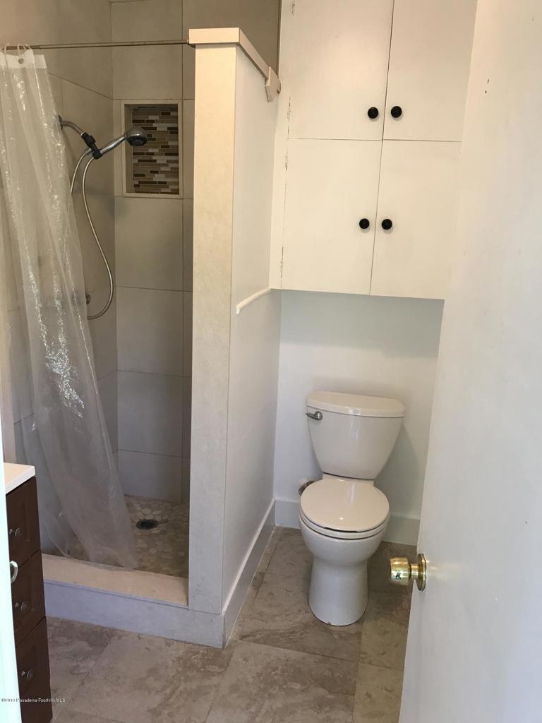 1445 East Woodbury Road, Unit REAR Pasadena, CA 91104 - Photo 9 of 17 a bathroom with a toilet and a shower