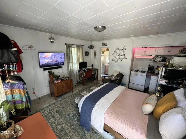 a bed room with two bed and a flat screen tv