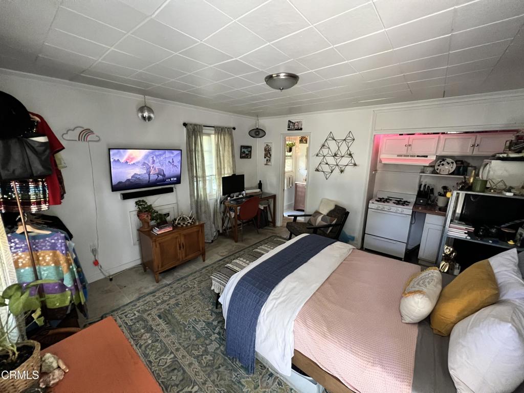 1445 East Woodbury Road, Unit REAR Pasadena, CA 91104 - Photo 10 of 17 a bed room with two bed and a flat screen tv