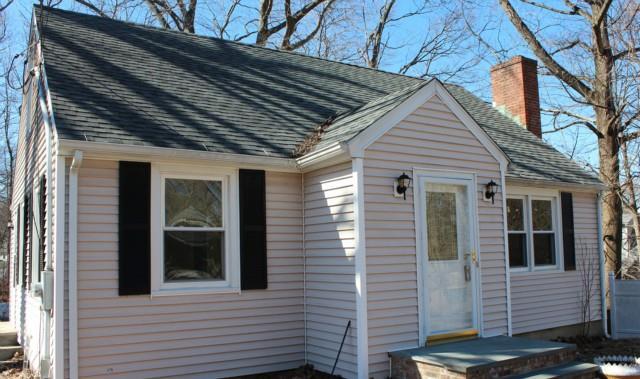 a view of a house with a door and wooden roof