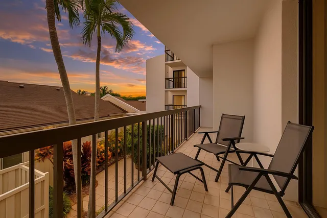 a view of a chairs and table in patio with a small yard