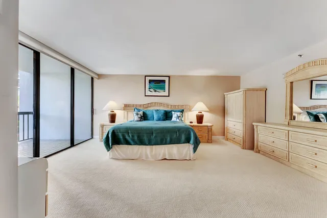 a bedroom with a large bed and a flat tv screen