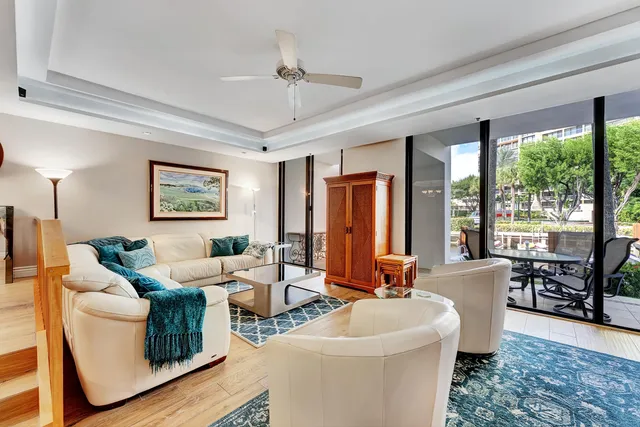 a living room with furniture and large windows