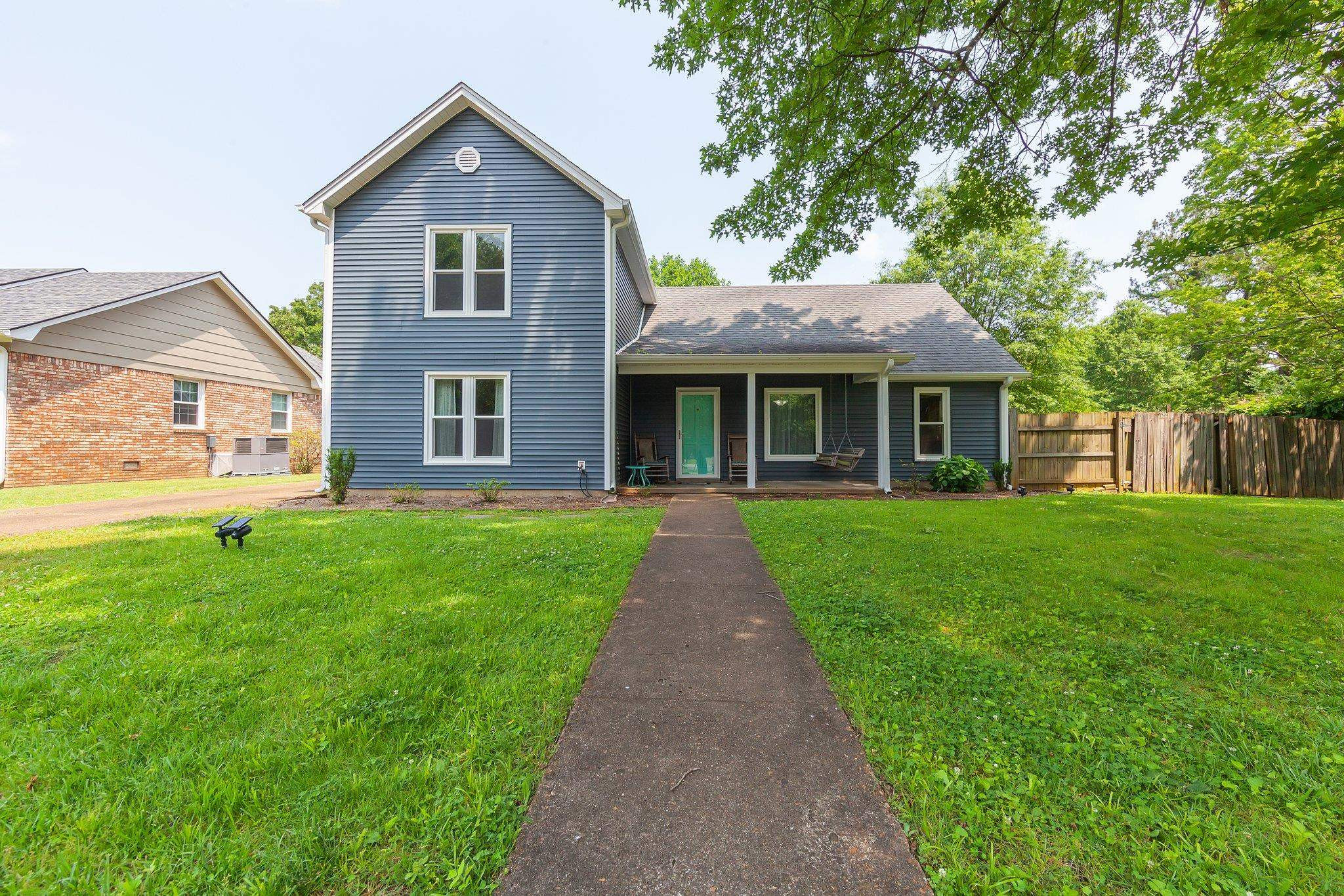 a front view of a house with a yard and porch