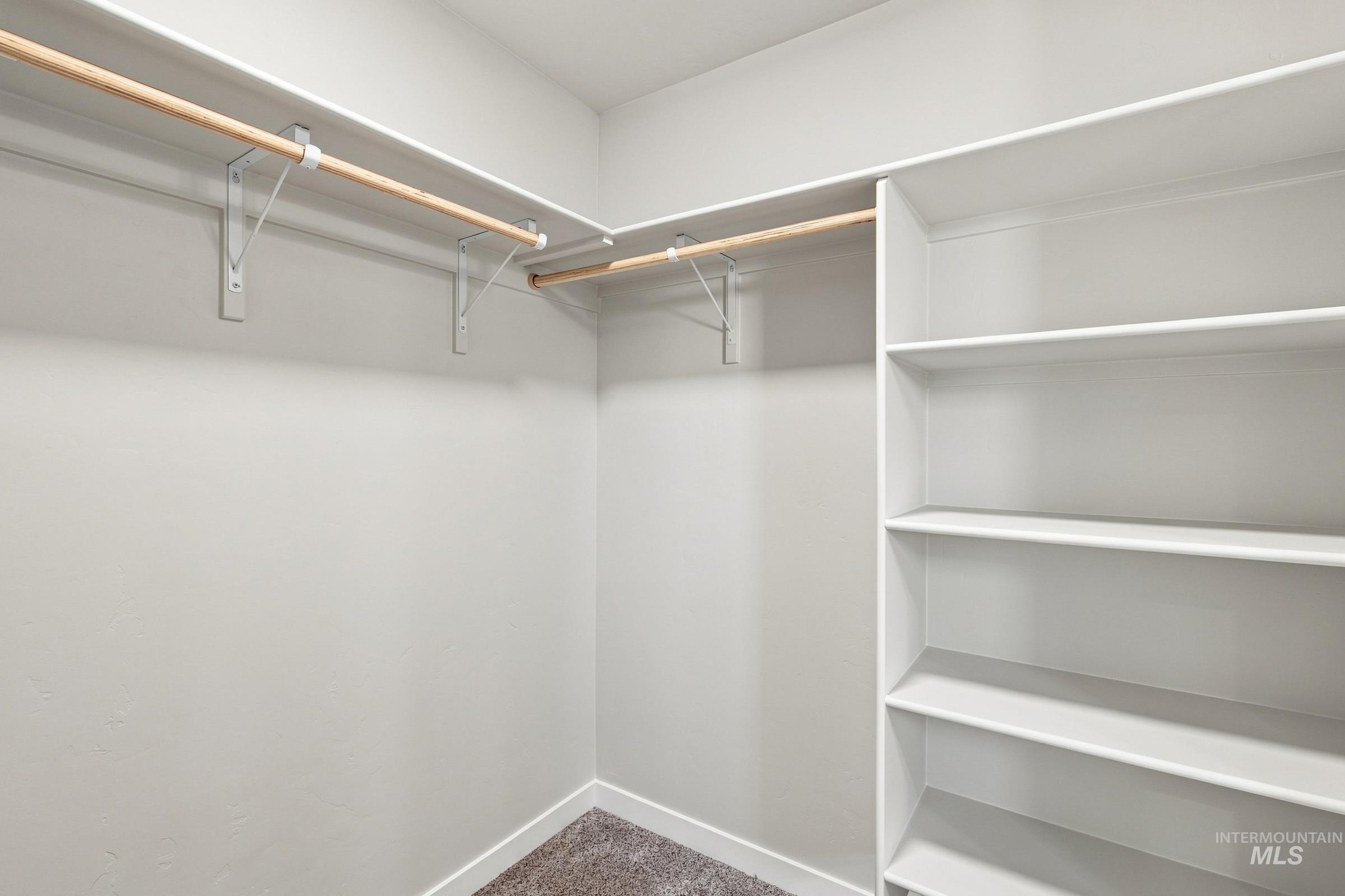 464 Merlin Court Middleton, ID 83644 - Photo 25 of 26 Walk-in closet featuring built-in shelving, two hanging rods, and light-toned wall finishes