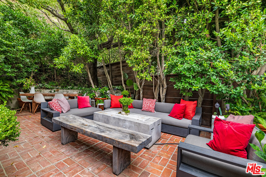 1438 San Ysidro Drive Beverly Hills, CA 90210 - Photo 12 of 40 a outdoor space with patio the couches and a potted plant on a table and a chairs