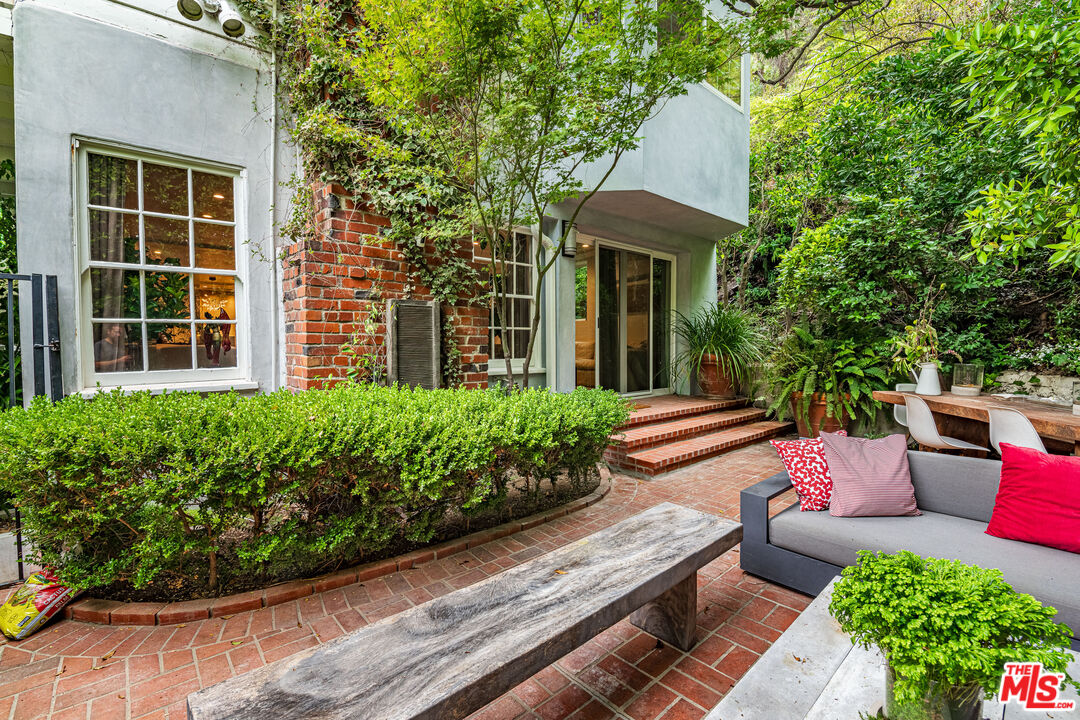 1438 San Ysidro Drive Beverly Hills, CA 90210 - Photo 13 of 40 a view of a house with sitting area and garden