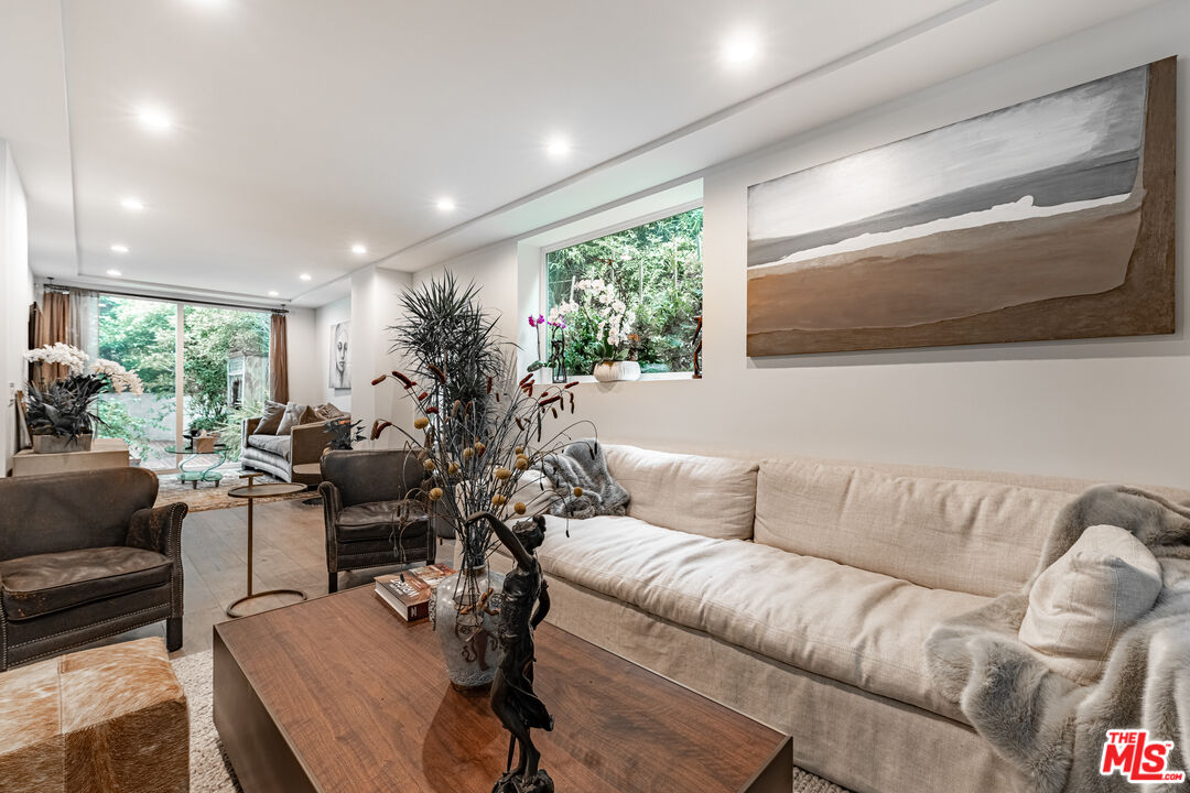 1438 San Ysidro Drive Beverly Hills, CA 90210 - Photo 14 of 40 a living room with furniture and a flat screen tv
