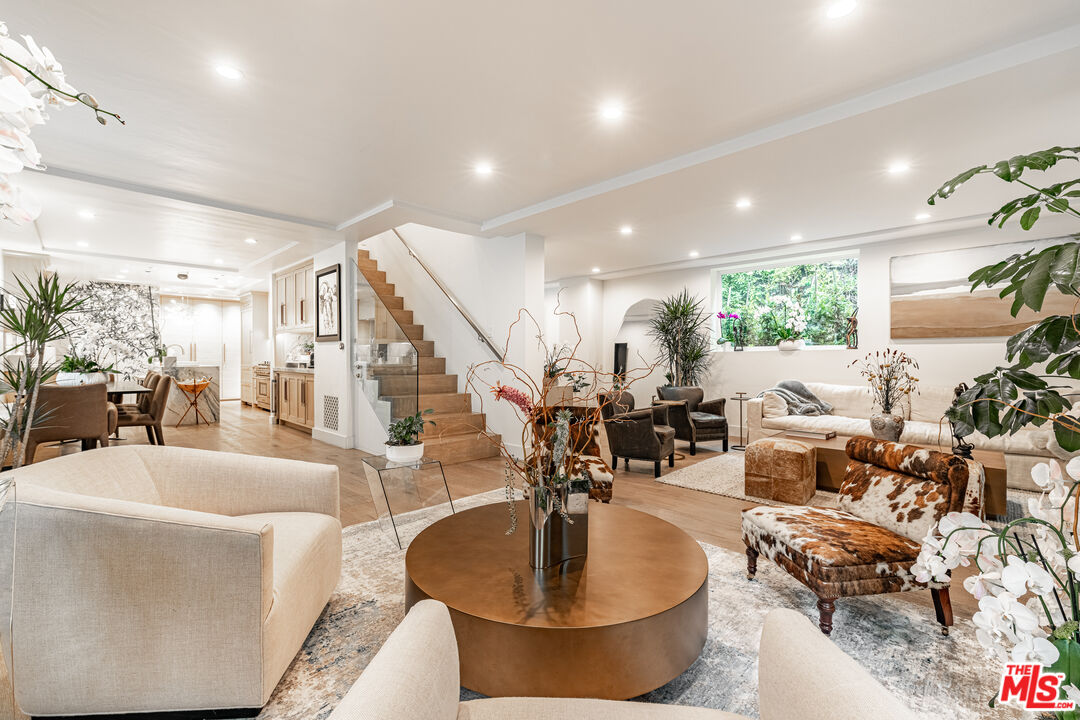 1438 San Ysidro Drive Beverly Hills, CA 90210 - Photo 15 of 40 a living room with furniture and a chandelier