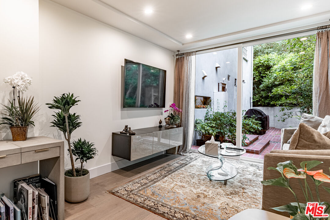 1438 San Ysidro Drive Beverly Hills, CA 90210 - Photo 16 of 40 a living room with furniture and a potted plant