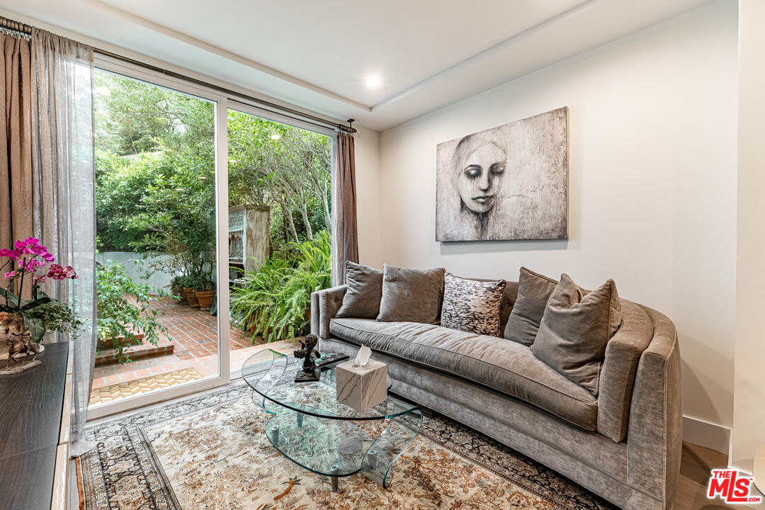 1438 San Ysidro Drive Beverly Hills, CA 90210 - Photo 17 of 40 a living room with furniture and a large window