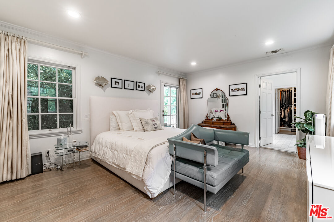 1438 San Ysidro Drive Beverly Hills, CA 90210 - Photo 21 of 40 a bedroom with a bed and wooden floor